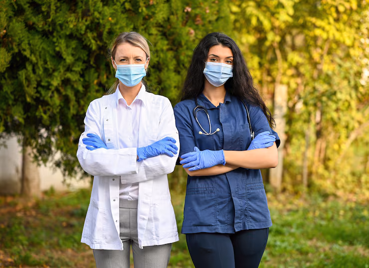 shallow-focus-shot-doctors-wearing-face-masks-outdoors_181624-47081